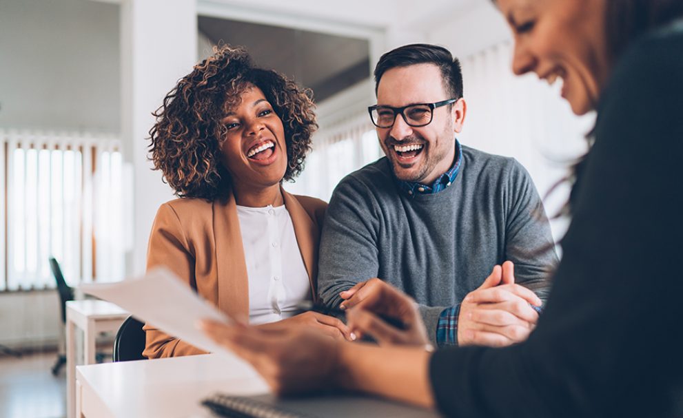 Happy couple applying for a loan