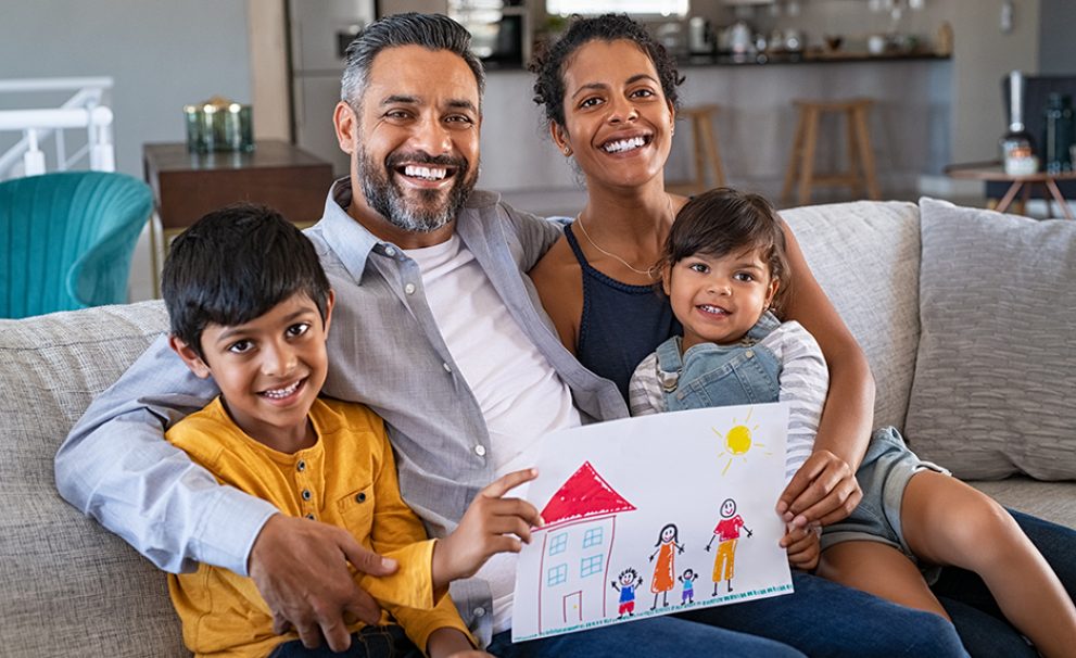 Happy family showing painting with new home