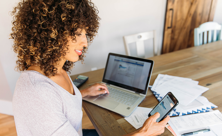 Woman Doing Finances at Home on Smart Phone